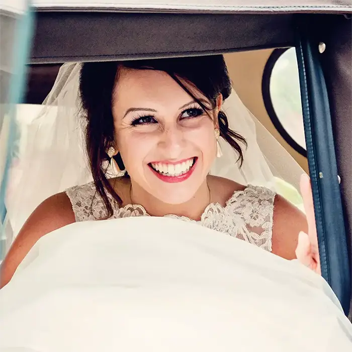 Bride smiling as she arrives in her carriage to her wedding in Worcester