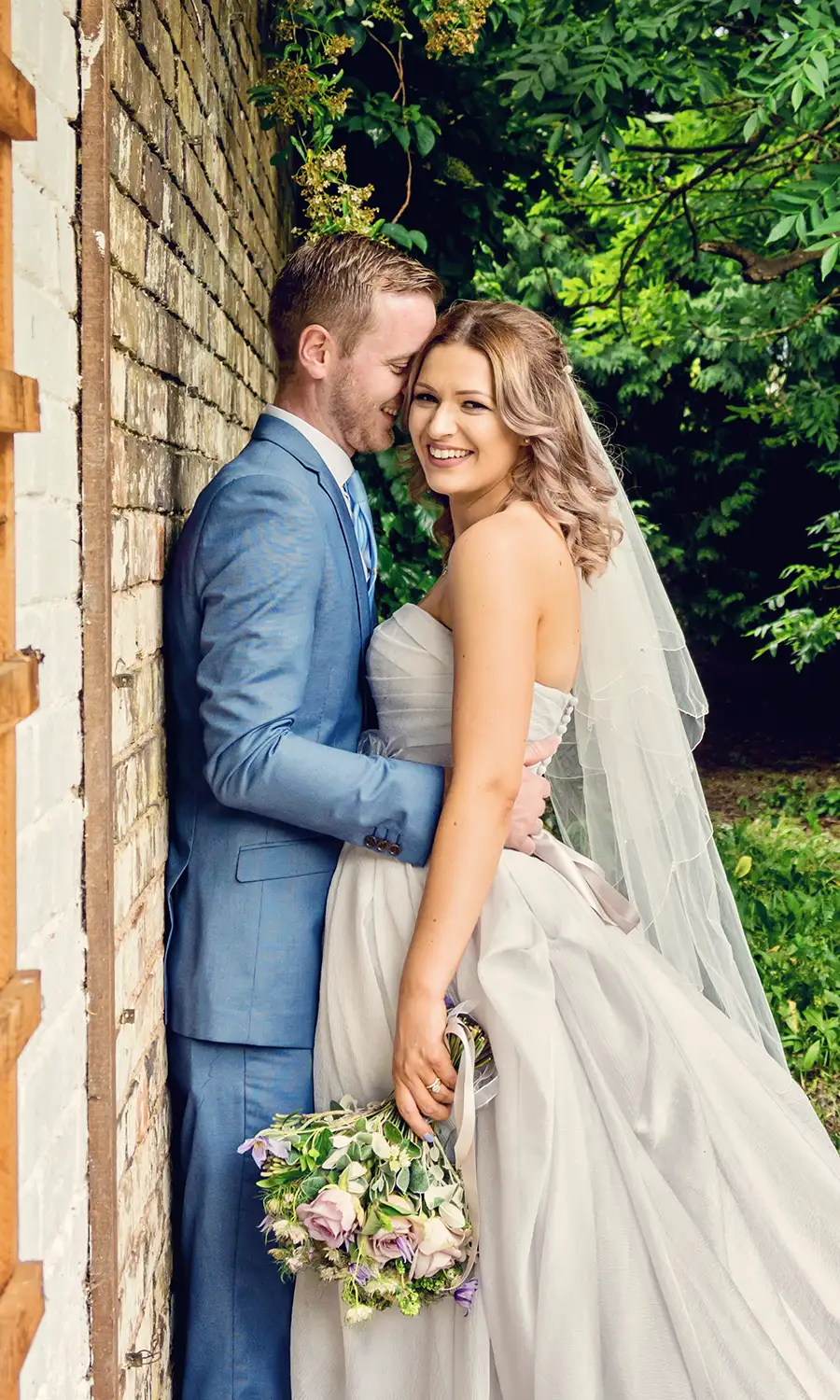 Newlyweds outside a historic church in Droitwich Spa Newlyweds outside a historic church in Droitwich Spa