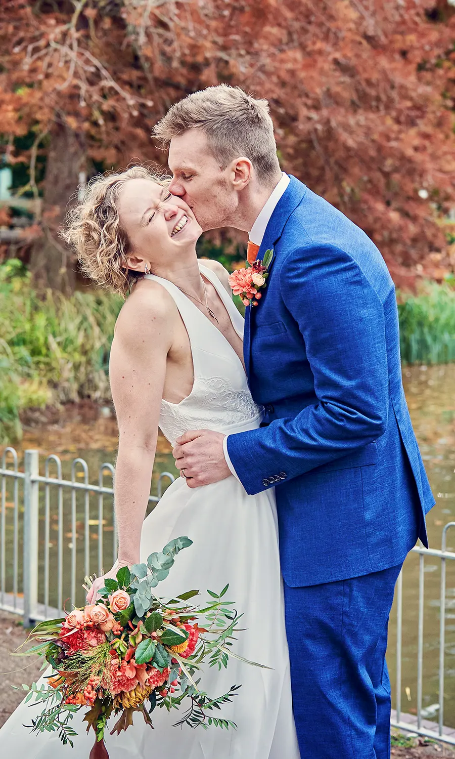 A fun moment as the groom tries to kiss the bride's cheek in Leamington Spa