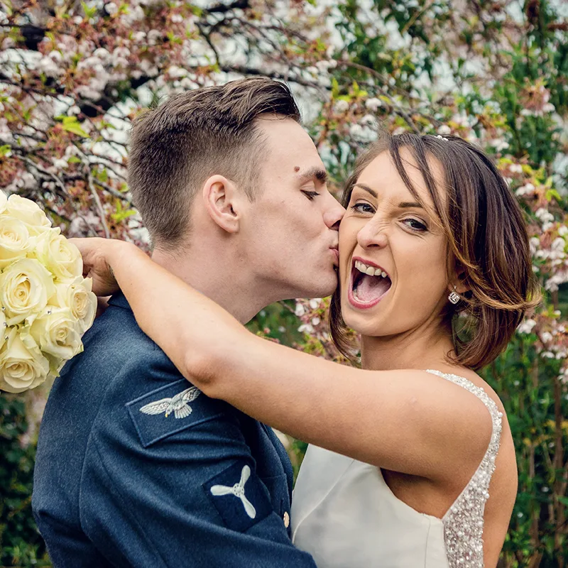 Newlyweds having fun outside Worcester cathedral